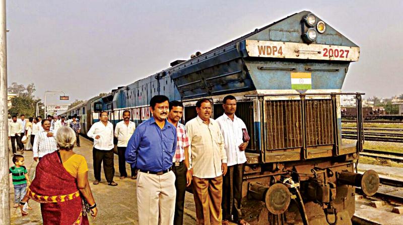 Court staff and advocates with the seized Dharwad-Mysuru inter-city train in Harihar on Monday.