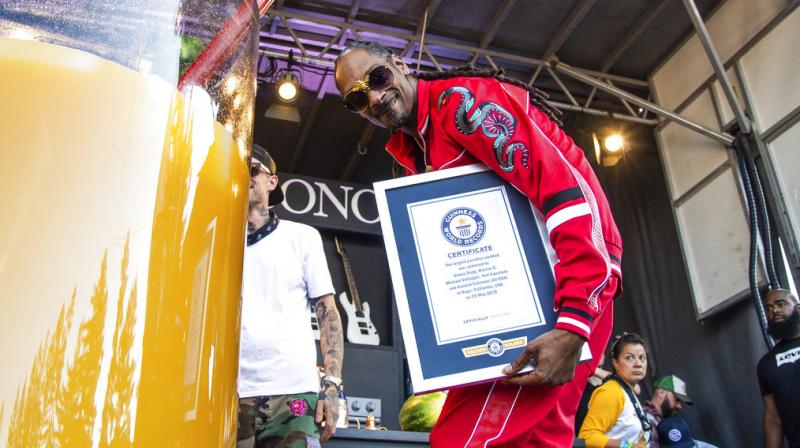 A representative from the Guinness organisation presented Snoop with his record certificate. (Photo: AP)