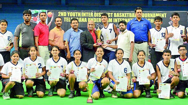 Hyderabad boys and girls basketball teams are all smiles as they pose with the trophies after winning the second Youth Inter-District Basketball tournament that was played recently at the Kotla Vijaya Bhasker Reddy Stadium at Yousufguda.