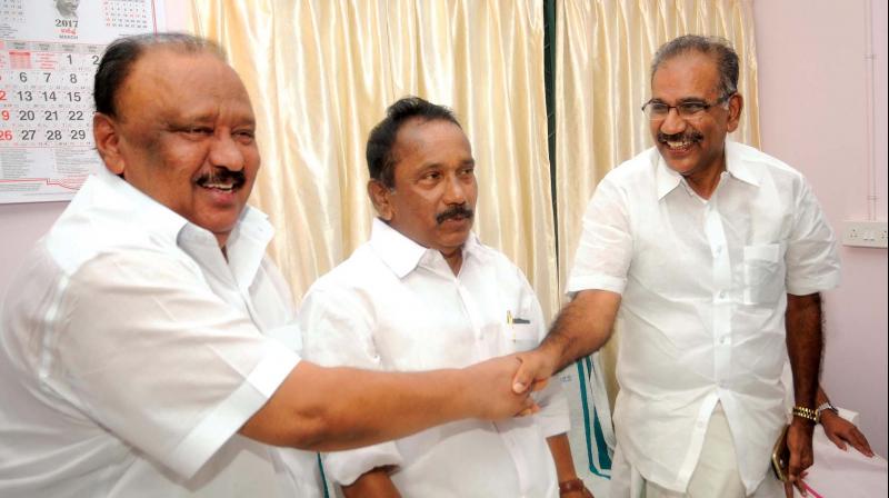 Thomas Chandy, MLA, who is expected to replace former minister A. K. Saseendran being congratulated by the latter at the NCP state leadership meeting in Thiruvananthapuram on Tuesday. Party state president Uzhavur Vijayan looks on. (Photo: A.V. MUZAFAR)