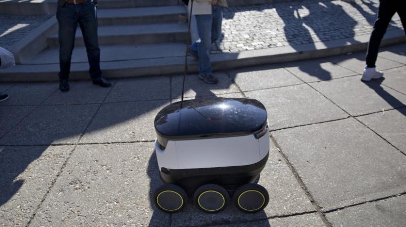A six-wheeled ground delivery robot, from Starship Technologies, shares the sidewalk with pedestrians at DuPont Circle in Washington, D.C. Photo:AP