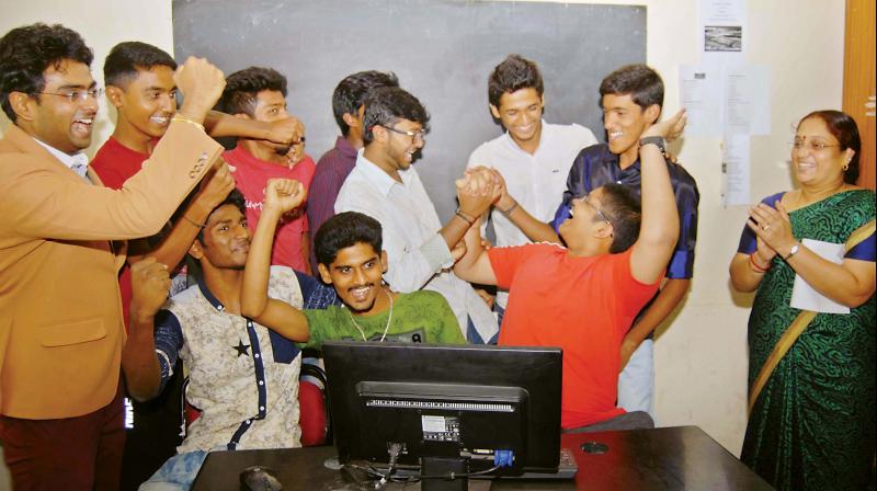 Students celebrate after checking the PU results on the net at a college in Bengaluru.