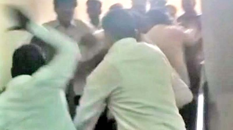 Lawyers thrash an accused outside Mahila Court, on Tuesday.