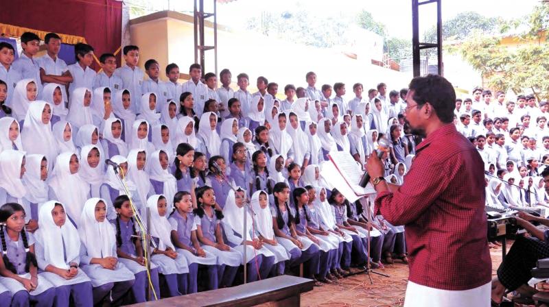 Students sing at Ragamalika programme.