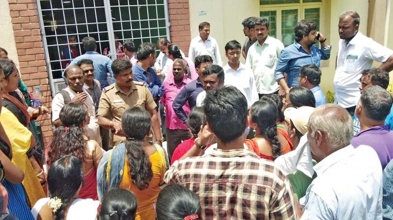 Parents protest outside the school in Kolappakkam on Thursday. (Photo:DC)