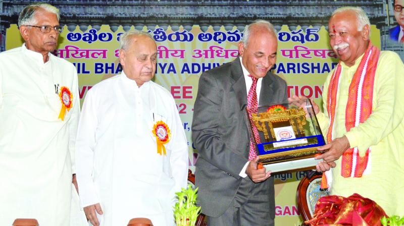RSS chief Mohan Bhagwat presents a memento to Mr Vinay Deekshit, president of the Akhil Bharatiya Adhivakta Parishad, an organisation of lawyers, at the concluding session of its silver jubilee celebrations at the Saroornagar stadium in Hyderabad on Sunday. (Photo:DC)