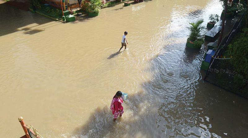 A waterlogged road at Anugraha Layout, Bilekahalli, due to heavy rainfall in the city, in Bengaluru on Sunday.  (Photo: Shahsidhar b. & R. Samuel)