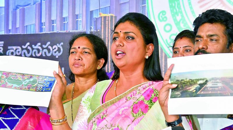 YSR Congress MLA R.K. Roja shows the new capital city complex designs at the Assembly media point at Velagapudi on Saturday. (Photo: PTI)