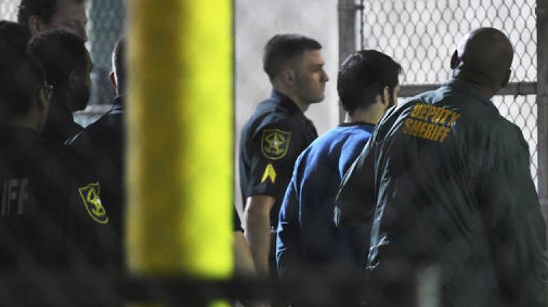 Esteban Santiago, 26, the suspect in the deadly shooting at Fort Lauderdale-Hollywood International Airport, is transported to the Broward County Main Jail by authorities. (Photo: AP)