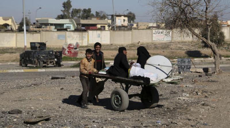 Civilians return to their liberated neighborhoods in the eastern side of Mosul, Iraq. (Photo: AP)