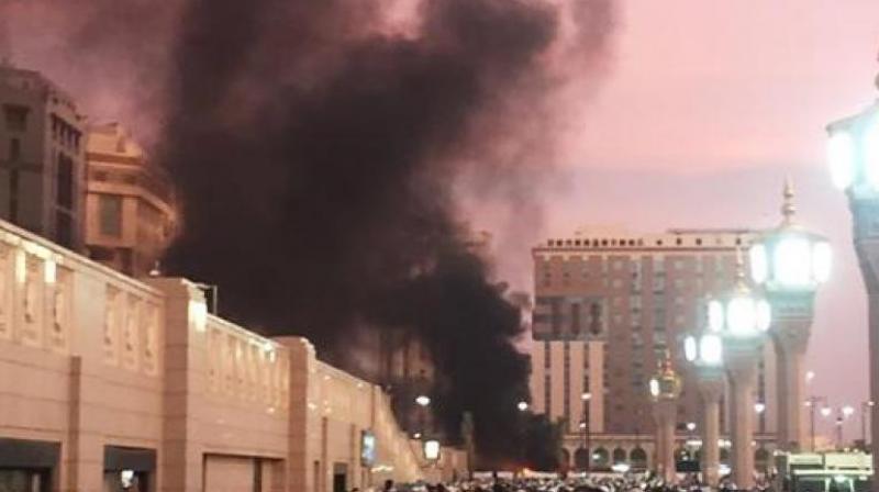 In this photo provided by Noor Punasiya, people stand by an explosion site in Medina, Saudi Arabia. (Photo: AP)