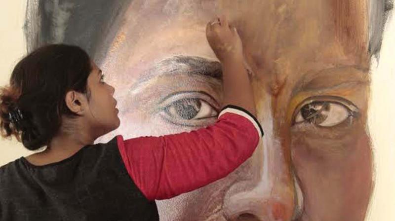 Sherin Nazar B- Arch student of NIT-C working on a painting of PT Usha on Monday at Usha School of Athletics. (Photo: DC)