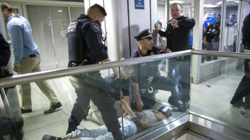 New York City police officers detain a passenger from a disabled New Jersey Transit train who became belligerent and sparked a stampede among passengers leaving the overcrowded station once the train finally arrived at New Yorks Penn Station, Friday, April 14, 2017. (Photo: AP)