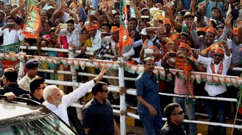 Prime Minister Narendra Modi waves to supporters at Bhubaneswar airport on Saturday. (Photo: PTI)