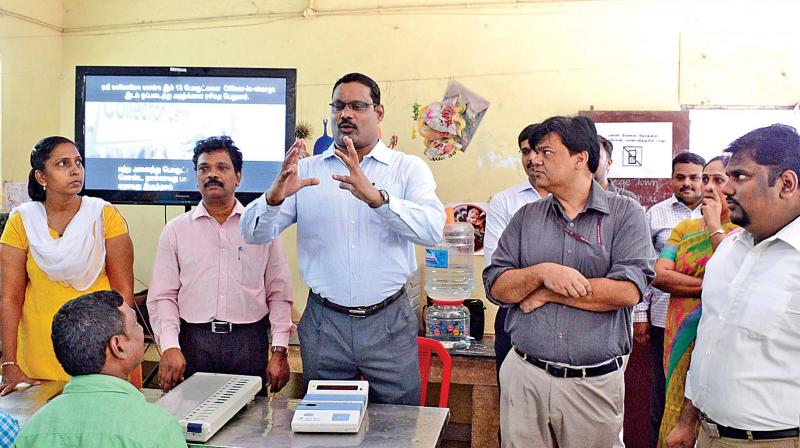 Chennai corporation commissioner and district election officer D. Karthikeyan briefs polling officers assigned during a training programe held at corporation school in New Washermenpet on Saturday. RK Nagar election returning officer Praveen Nair also seen. (Photo: DC)