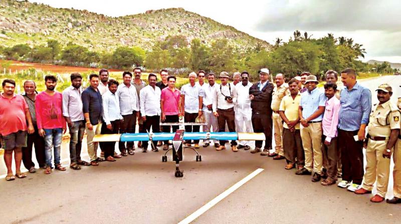 Volunteers from the NGO, SayTrees, and officials from the forest department with the drone, used to distribute seeds on Kallinayakanahalli hills of Gowribidanur.(Image Dc)