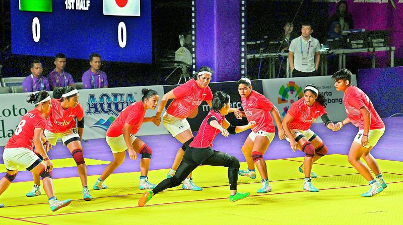 Indian women kabaddi players try to trap a Japanese raider during their match on Sunday. India won 43-12.	AFP