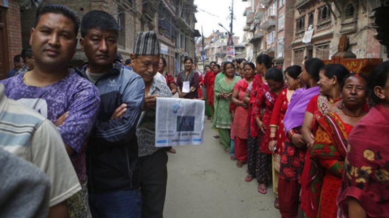Nepalese stand in a queue to cast their votes at a polling station during the local election in Bhaktapur, Nepal. (Photo: AP)