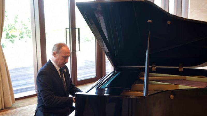 Russian President Vladimir Putin plays piano before his talks with Chinese President Xi Jinping prior to the opening ceremony of the Belt and Road Forum in Beijing. (Photo: AP)