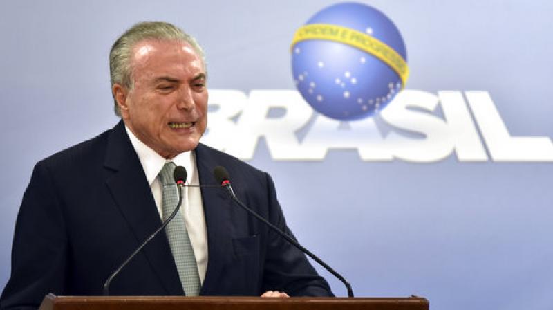 Brazils President Michel Temer says he will fight allegations that he endorsed the paying of hush money to an ex-lawmaker jailed for corruption, during a national address at the Planalto presidential palace in Brasilia, Brazil. (Photo: AP)