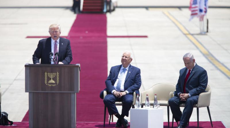 US President Donald Trump speaks during welcome ceremony in Tel Aviv, accompanied by Israels President Reuven Rivlin, center, and Prime Minister Benjamin Netanyahu