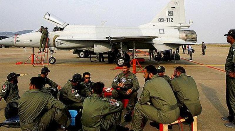 Pakistan Air Force personnel sit in front of their JF-17 jet fighter. (Photo: File/AP)