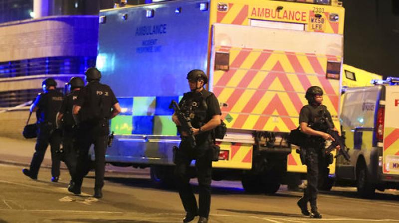 Armed police work at Manchester Arena after reports of an explosion at the venue during an Ariana Grande gig in Manchester, England. (Photo: AP)