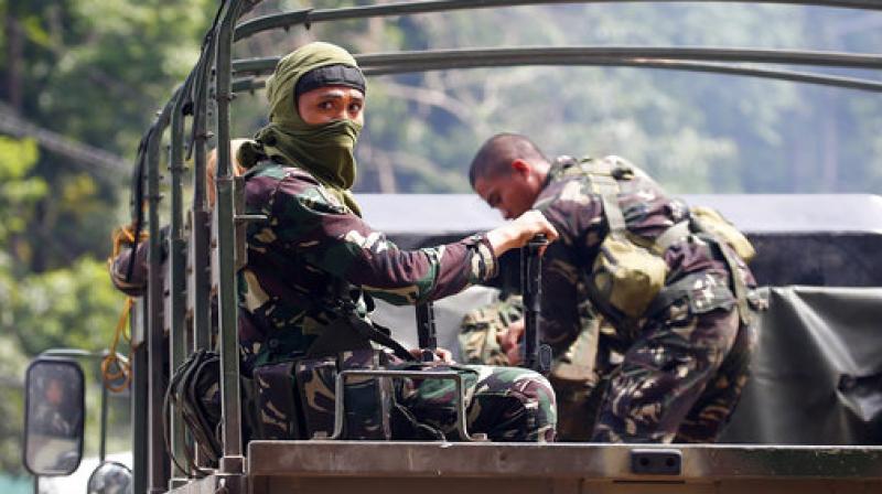 Government soldiers on military vehicles patrol after a continued assault on fighters from the Maute group who have taken over large parts of Marawi city, southern Philippines. (Photo: AP)