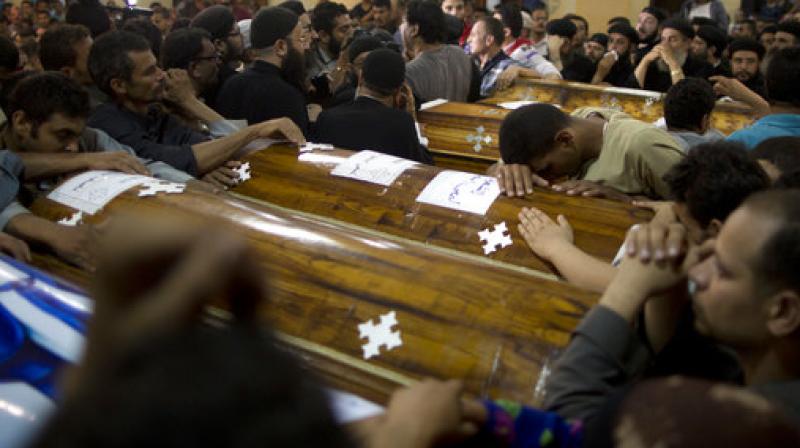 Relatives of Coptic Christians who were killed during a bus attack, mourn by their coffins during a funeral service, at Abu Garnous Cathedral in Minya, Egypt. (Photo: AP)