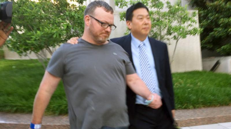 Bryan Moles, left, leaves court with attorney Eugene Ohm on Thursday, in Washington. Moles was arrested at Trump International Hotel in downtown Washington on Wednesday and faces charges of unlawful possession and transportation of a firearm. (Photo: AP)