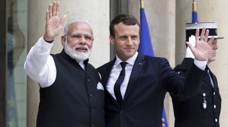 French President Emmanuel Macron, left, welcomes Indian Prime Minister Narendra Modi, before their meeting at the Elysee Palace in Paris, France. (Photo: AP)