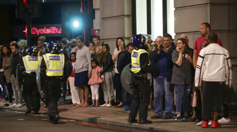 Guests from the Premier Inn Bankside Hotel are evacuated and kept in a group with police on Upper Thames Street following an incident in central London, Saturday. Terrorism struck at the heart of London, police said Sunday, after a vehicle veered off the road and mowed down pedestrians on London Bridge and gunshots rang out amid reports of knife attacks at nearby Borough Market. (Photo: AP)