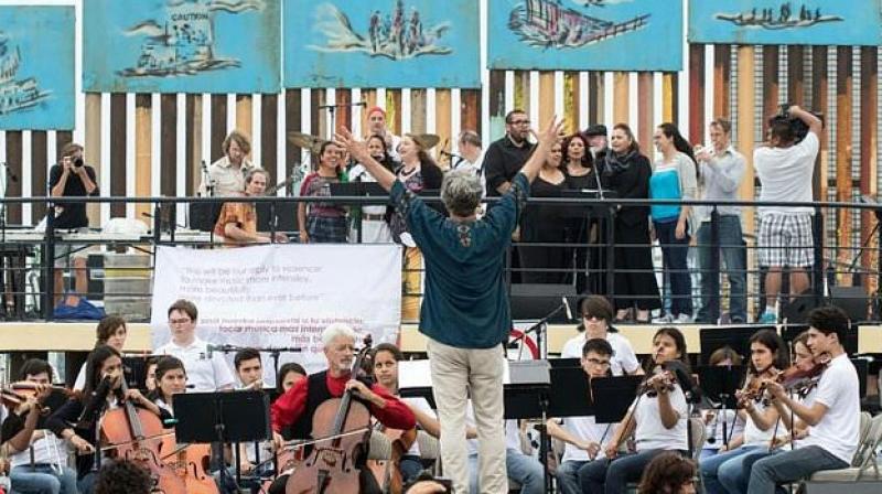 Musicians perform near the US-Mexico border during the \Tear Down This Wall\ concert in protest at US President Donald Trumps plans to build a dividing fence. (Photo: AFP)