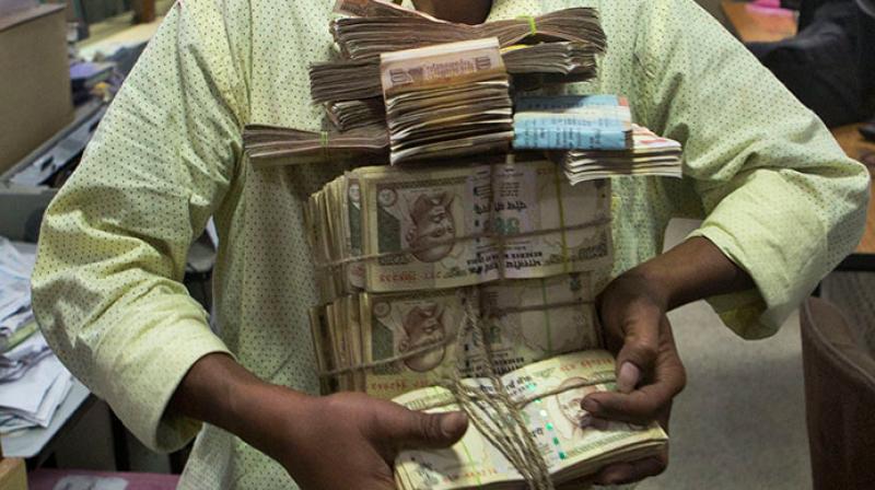 The I-T Department has slapped notices on 1.16 lakh individuals and firms who made cash deposits of more than Rs 25 lakh in bank accounts post note ban but failed to file returns by the due date. (Photo: AP/Representational)