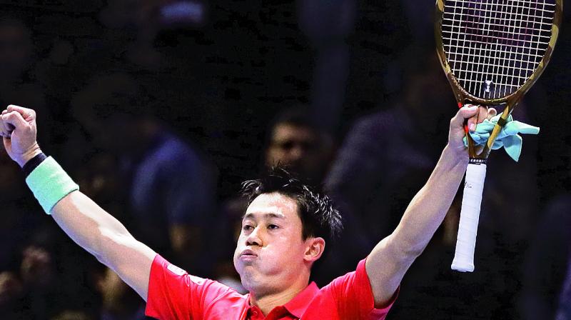 Kei Nishikori celebrates after winning the match against Roger Federer in the mens singles final of the ATP World Tour Finals. 	(Photo: AP )