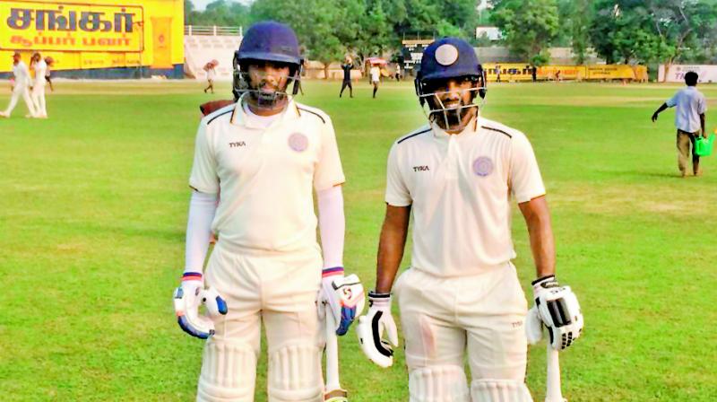 Hyderabad captain Akshath Reddy (left) and B. Sandeep return to the pavilion after their 136-run unbroken stand for the fourth wicket in the Ranji Trophy match against Tamil Nadu on Monday.