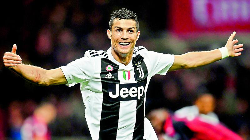 Cristiano Ronaldo of Juventus celebrates after scoring during their Italian league match against AC Milan at the San Siro stadium in Milan.	(Photo:AFP)