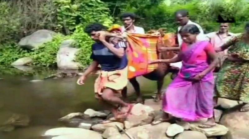 A pregnant woman being carried to hospital by her family members in Kerala. (Photo: ANI | Twitter)