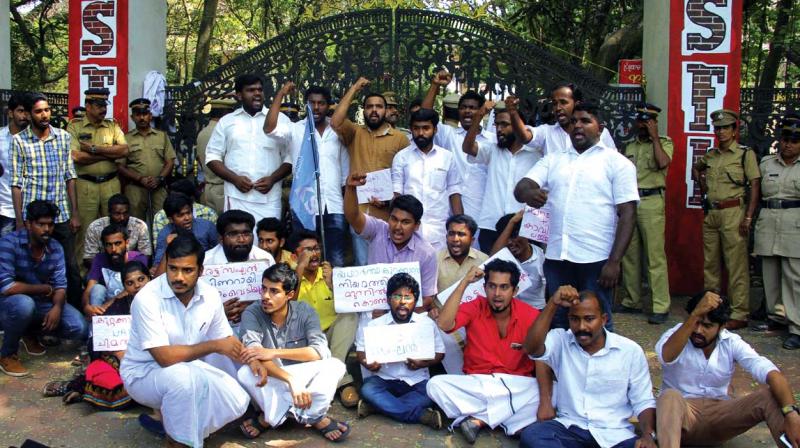 KSU activists in front of the Maharajas college on Thursday in protest against the  police arresting six students of the college on Wednesday. (Photo:  DC)
