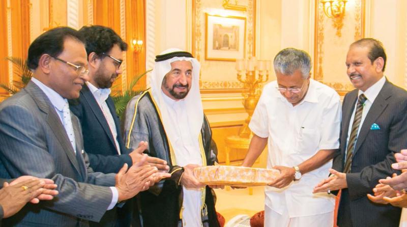 Chief Minister Pinarayi Vijayan and Sharjah ruler Dr. Sheikh Sultan Bin Mohammed Al Qassimi exchange gifts during their meeting in Sharjah. Sharjah Indian Association president Y.A. Rahim, Yusuffali M.A. and John Brittas are also seen.