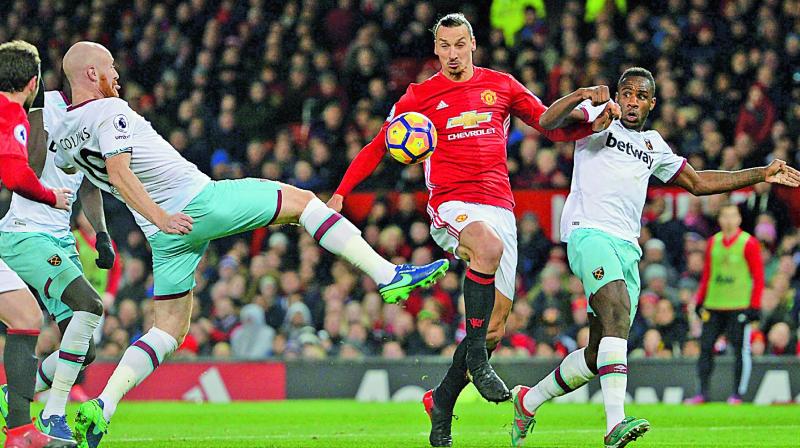 Manchester United striker Zlatan Ibrahimovic (second from right) vies for the ball with West Ham United players in their English Premier League match at Old Trafford on Sunday (Photo: AFP)