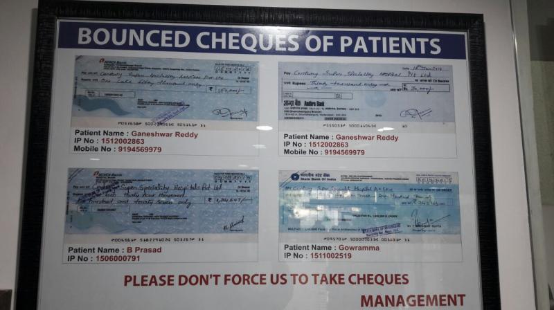 The notice board naming people whose cheques have bounced.