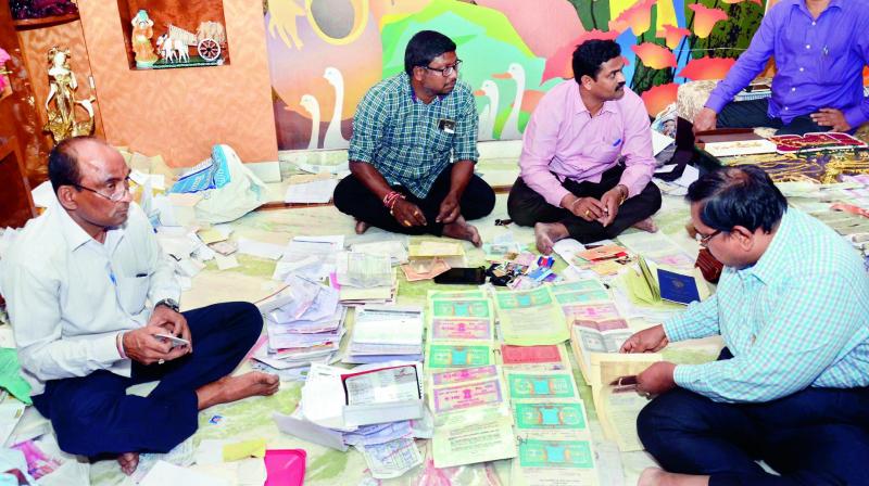 ACB sleuths check the documents seized from joint director Gopuram Muni Venkata Narayana on Saturday. (Photo: DC)