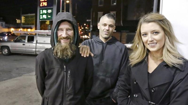 In this November 17, 2017 photo, Johnny Bobbitt Jr (left), Kate McClure (right), and McClures boyfriend Mark DAmico pose at a CITGO station in Philadelphia. When McClure ran out of gas, Bobbitt, who is homeless, gave his last $20 to buy gas for her. McClure started a Gofundme.com campaign for Bobbitt that has raised more than $100,000. (Photo: AP)