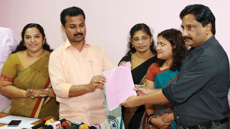 Corporation secretary M. Nizarudeen hands over the agreement copy that was signed with iDeCK officials to mayor V.K. Prasanth on Saturday. (Photo: DC)