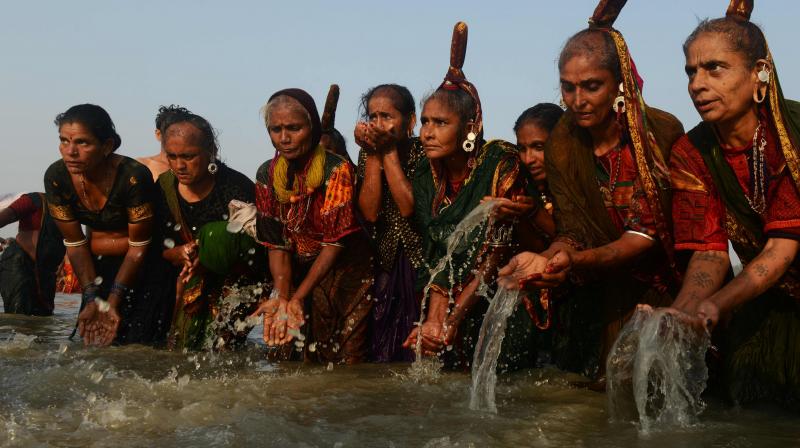 Indian Hindu devotees from a tribal community take a holy bath in the Bay of Bengal and perform rituals at the mouth of the river Ganges on Sagar Island, around 150km south of Kolkata, on January 14, 2017.(Photo: AFP)