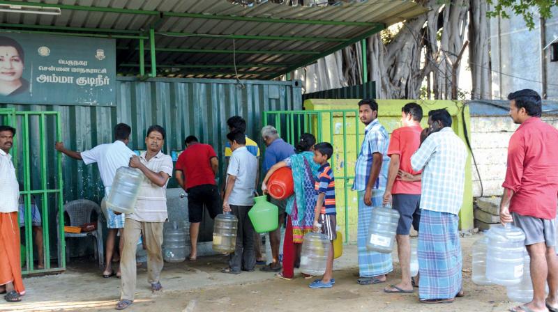 People wait near Chennai Corporation Amma drinking water centre at Moggapair on Wednesday as drinking water lorries and private suppliers went on strike. (Photo: DC)