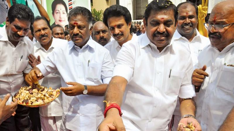 Chief Minister Edappadi K. Palaniswami and Deputy CM O. Panneerselvam distribute sweets on the occasion of AIADMKs 47th year celebrations at the party office. They also launched helmet awareness campaign and mobile app for blood donation on Wednesday. (Photo: DC)