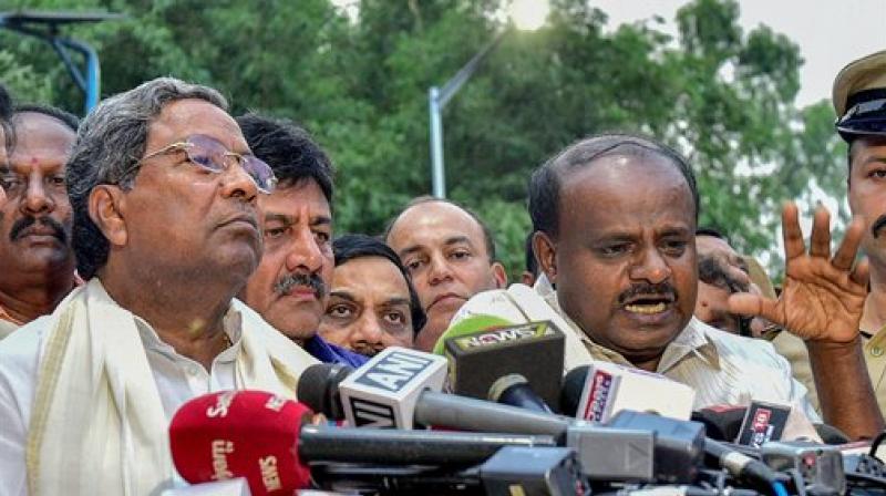 Outgoing Karnataka Chief Minister Siddaramaiah and JD(S) President HD Kumaraswamy address the media after a meeting with Governor Rudabhai Vala in relation with in Bengaluru on Tuesday. (Photo: PTI)