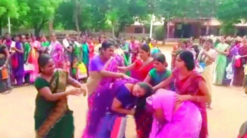 Women pull each others hair, while waiting to receive their sari, which the TS government is distributing for the Bathukamma festival, a nine-day event that coincides with Dasara. Other women in the lines tried to break up the fights to no avail. A majority of the saris were sourced from Surat in Gujarat that has irked the weavers of Telangana. (Photo: DC)